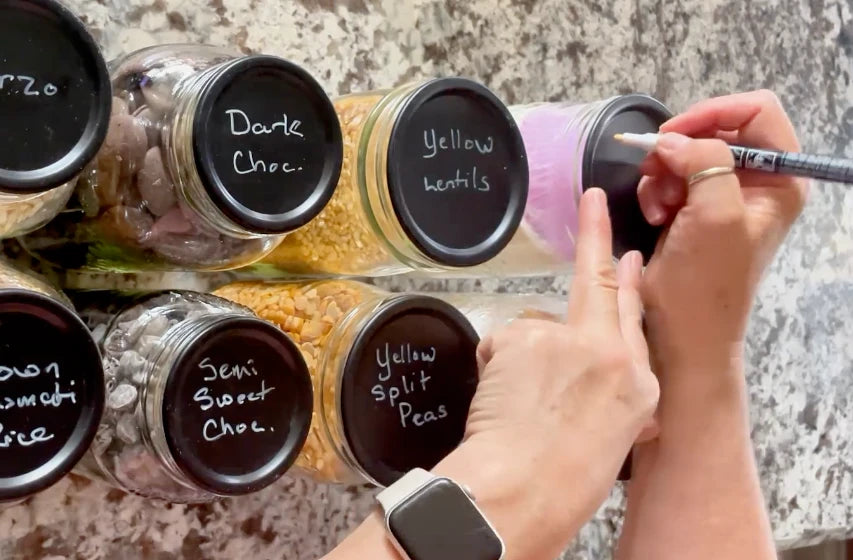 Labelling the reusable chalkboard-top mason jar lids